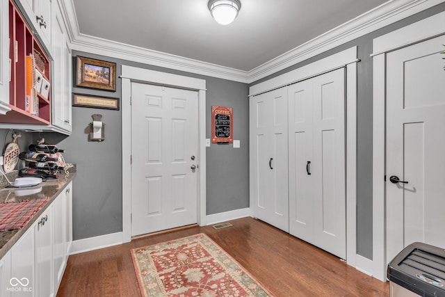 900 W Busby St, Lebanon, IN 46052 - foyer entrance featuring dark wood-style flooring and crown molding
