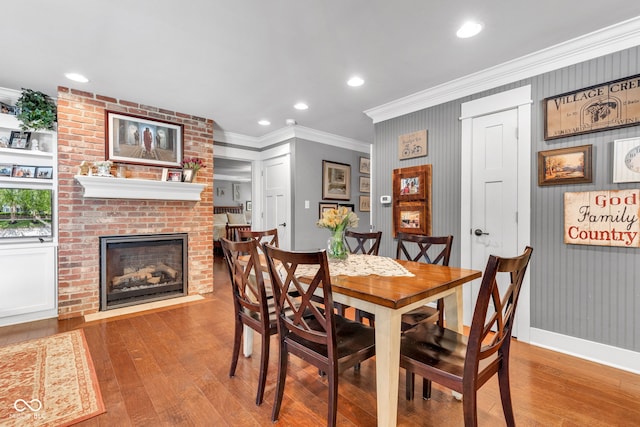 900 W Busby St, Lebanon, IN 46052 - dining room featuring wood-type flooring, crown molding, a brick fireplace, and recessed lighting