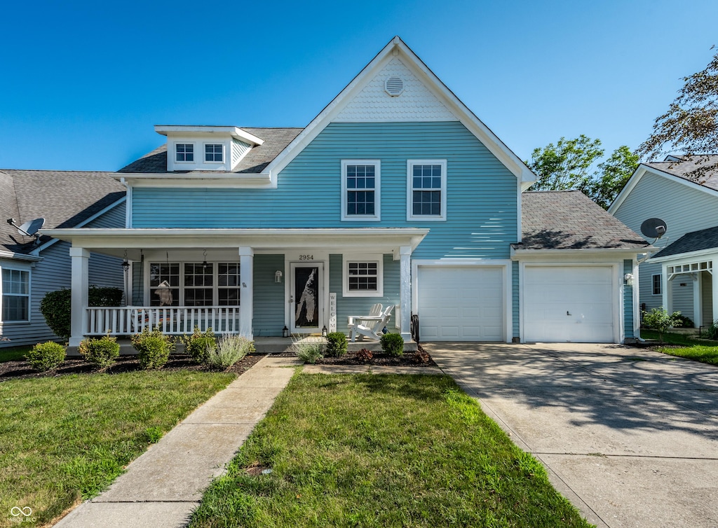 2954 Weatherstone Dr, Carmel, IN 46032 - view of front of house with driveway, a front yard, covered porch, and a shingled roof
