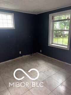 1724-1726 N Somerset Ave, Indianapolis, IN 46222 - unfurnished room featuring a textured ceiling and baseboards