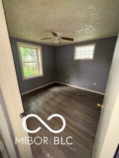 1724-1726 N Somerset Ave, Indianapolis, IN 46222 - unfurnished bedroom with wood finished floors, a textured ceiling, baseboards, and ceiling fan