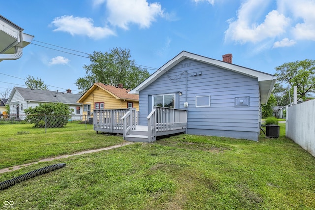 3906 Fletcher Ave, Indianapolis, IN 46203 - rear view of house with central air condition unit, a chimney, and a wooden deck