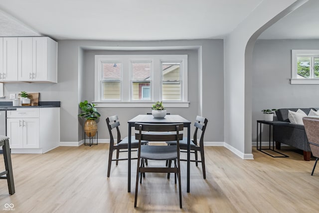 3906 Fletcher Ave, Indianapolis, IN 46203 - dining space with light wood-style floors, arched walkways, and baseboards