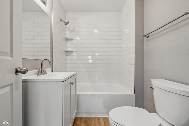 3906 Fletcher Ave, Indianapolis, IN 46203 - bathroom featuring toilet, vanity, washtub / shower combination, and wood finished floors