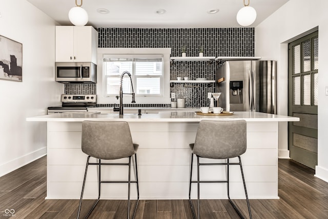 805 N Temple Ave, Indianapolis, IN 46201 - kitchen featuring stainless steel appliances, pendant lighting, backsplash, a center island with sink, and dark wood-type flooring