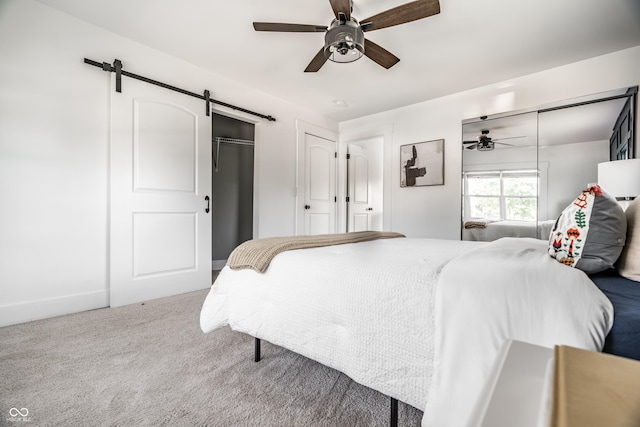 805 N Temple Ave, Indianapolis, IN 46201 - carpeted bedroom with a barn door and a ceiling fan