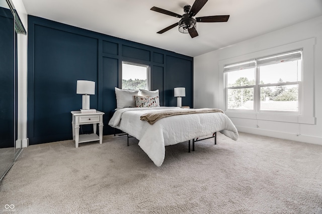 805 N Temple Ave, Indianapolis, IN 46201 - bedroom featuring multiple windows, a decorative wall, light colored carpet, and ceiling fan