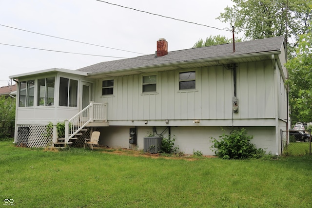 1713 Boca Raton Blvd, Kokomo, IN 46902 - back of property featuring a shingled roof, a chimney, a yard, and a sunroom