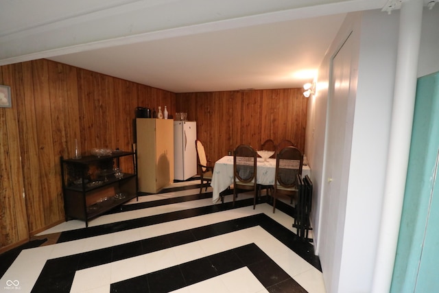 1713 Boca Raton Blvd, Kokomo, IN 46902 - tiled bedroom with wooden walls and freestanding refrigerator