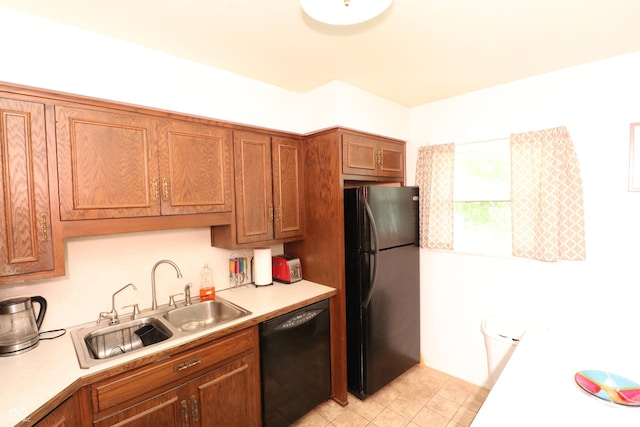 1713 Boca Raton Blvd, Kokomo, IN 46902 - kitchen featuring black appliances, a sink, light countertops, brown cabinetry, and light tile patterned flooring