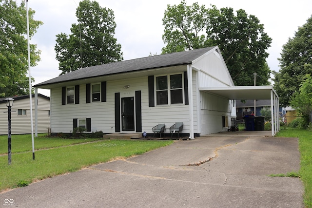 1713 Boca Raton Blvd, Kokomo, IN 46902 - view of front of home with driveway, a front lawn, an attached carport, and roof with shingles