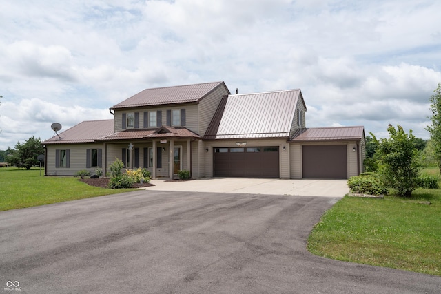 6170 County Road 39, Auburn, IN 46706 - view of front facade featuring a garage, driveway, a front yard, and a metal roof
