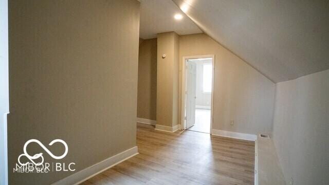 352 W 28th St, Indianapolis, IN 46208 - additional living space with wood finished floors, vaulted ceiling, and baseboards
