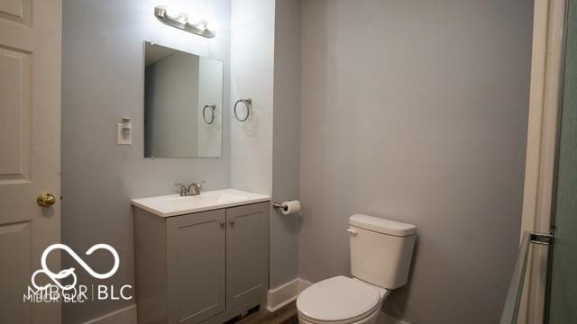 352 W 28th St, Indianapolis, IN 46208 - bathroom featuring toilet, vanity, and baseboards