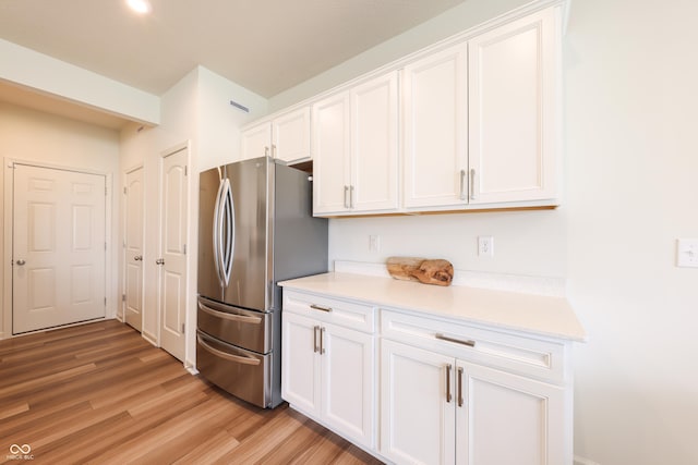 640 Axford Bay Dr, Westfield, IN 46074 - kitchen with freestanding refrigerator, white cabinetry, light countertops, and light wood-style floors