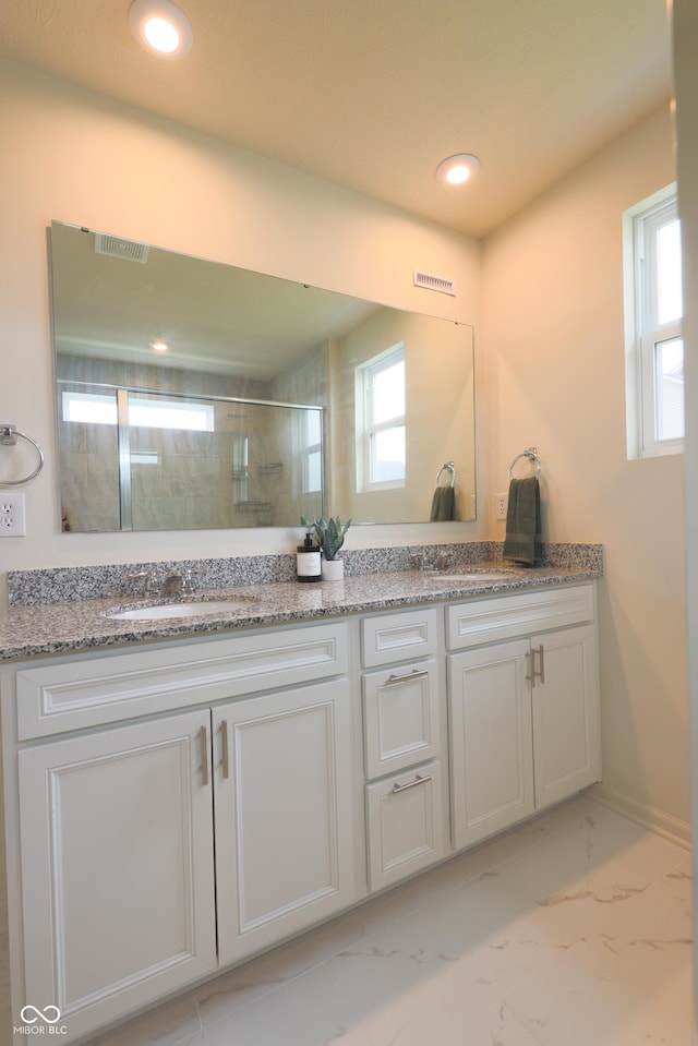 640 Axford Bay Dr, Westfield, IN 46074 - bathroom with marble look tile flooring, double vanity, healthy amount of natural light, and recessed lighting