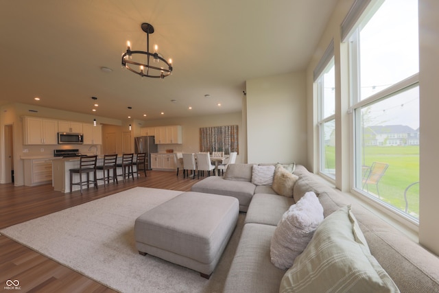 640 Axford Bay Dr, Westfield, IN 46074 - living area with a chandelier, healthy amount of natural light, light wood finished floors, and recessed lighting