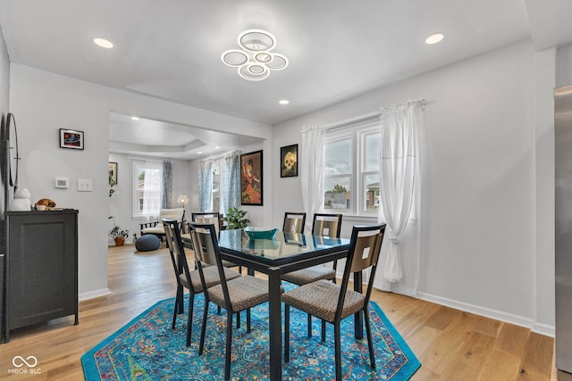 1618 Villa Ave, Indianapolis, IN 46203 - dining space with light wood-style flooring, recessed lighting, a raised ceiling, and baseboards