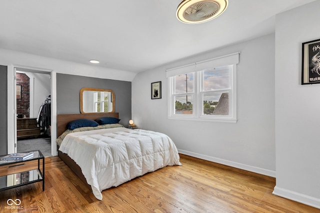 1618 Villa Ave, Indianapolis, IN 46203 - bedroom with baseboards, wood finished floors, and a walk in closet