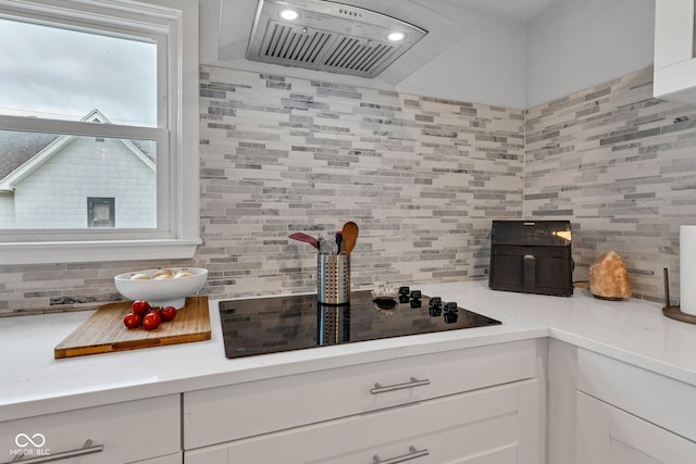 1618 Villa Ave, Indianapolis, IN 46203 - kitchen with tasteful backsplash, custom range hood, black electric cooktop, and light countertops