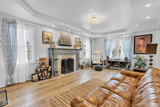 1618 Villa Ave, Indianapolis, IN 46203 - living room featuring a raised ceiling, hardwood / wood-style flooring, a fireplace with flush hearth, and recessed lighting