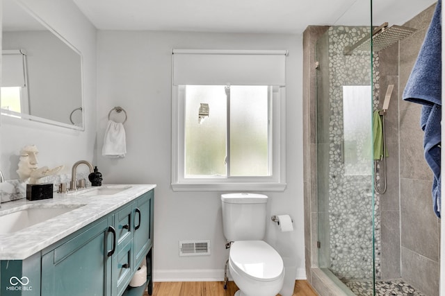 1618 Villa Ave, Indianapolis, IN 46203 - bathroom featuring double vanity, a shower stall, toilet, and wood finished floors
