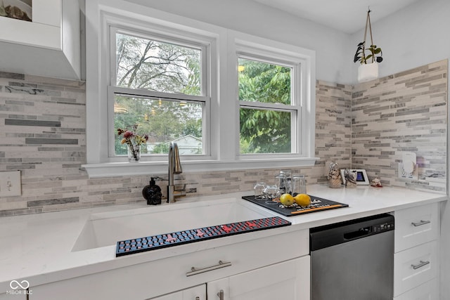 1618 Villa Ave, Indianapolis, IN 46203 - kitchen with stainless steel dishwasher, a sink, decorative backsplash, and white cabinetry