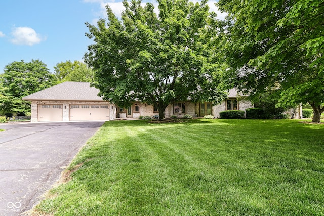 7220 Normandy Way, Indianapolis, IN 46278 - obstructed view of property featuring driveway, a garage, a front yard, and brick siding