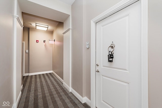 355 E Ohio St Unit 209, Indianapolis, IN 46204 - hall with baseboards and dark colored carpet