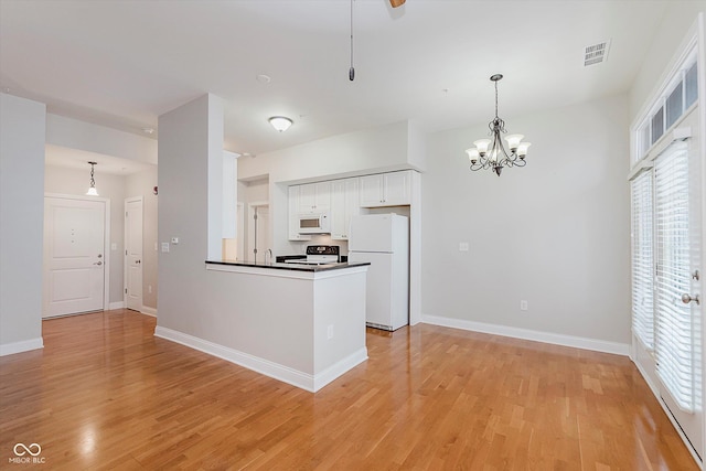 355 E Ohio St Unit 209, Indianapolis, IN 46204 - kitchen featuring white appliances, healthy amount of natural light, and light wood finished floors