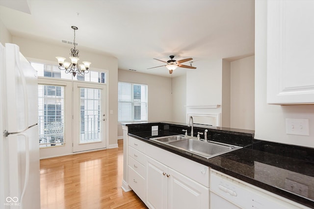 355 E Ohio St Unit 209, Indianapolis, IN 46204 - kitchen with white appliances, a sink, white cabinets, light wood-style floors, and decorative light fixtures