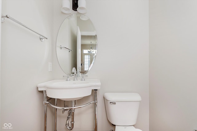 355 E Ohio St Unit 209, Indianapolis, IN 46204 - bathroom featuring toilet and a chandelier