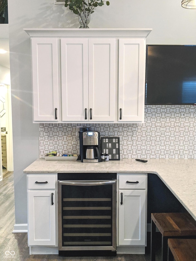 10421 Sand Creek Blvd, Fishers, IN 46037 - bar featuring beverage cooler, backsplash, and wood finished floors