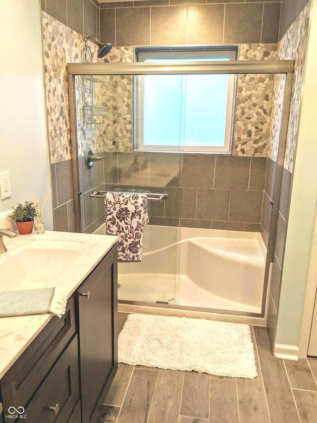 10421 Sand Creek Blvd, Fishers, IN 46037 - full bathroom featuring wood finished floors, vanity, and a stall shower