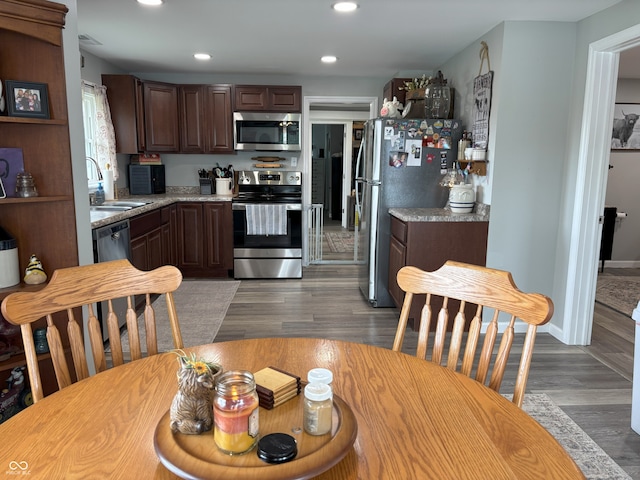 260 S 250 W, Greenfield, IN 46140 - kitchen featuring appliances with stainless steel finishes, a sink, light countertops, recessed lighting, and dark brown cabinetry