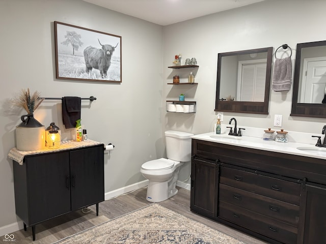 260 S 250 W, Greenfield, IN 46140 - bathroom with wood finished floors, double vanity, toilet, and baseboards