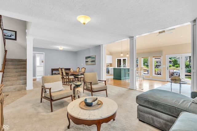 103 Gettysburg, Coatesville, IN 46121 - living room with decorative columns, a textured ceiling, stairs, and ceiling fan