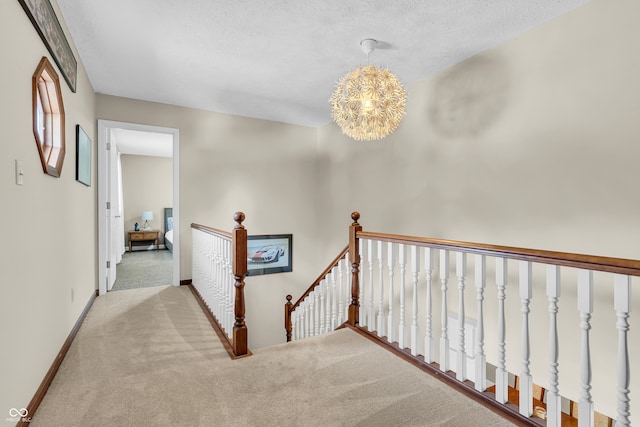 103 Gettysburg, Coatesville, IN 46121 - hallway with an upstairs landing, carpet floors, a textured ceiling, and a chandelier