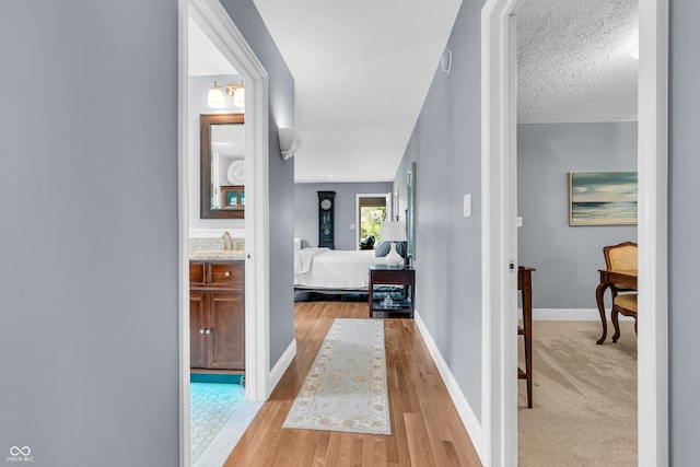 103 Gettysburg, Coatesville, IN 46121 - hallway featuring light wood finished floors and a textured ceiling