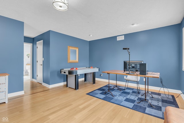 103 Gettysburg, Coatesville, IN 46121 - recreation room featuring wood finished floors, a desk, and a textured ceiling