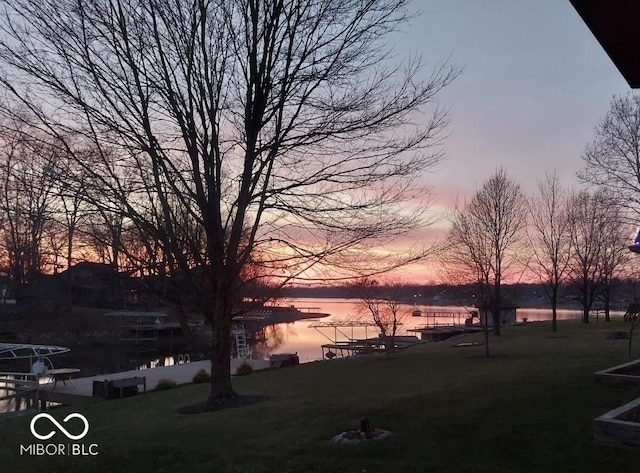103 Gettysburg, Coatesville, IN 46121 - yard at dusk featuring a water view and a lawn