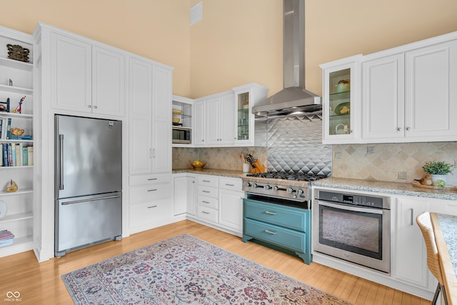 103 Gettysburg, Coatesville, IN 46121 - kitchen featuring stainless steel appliances, open shelves, exhaust hood, white cabinetry, and light wood-style flooring