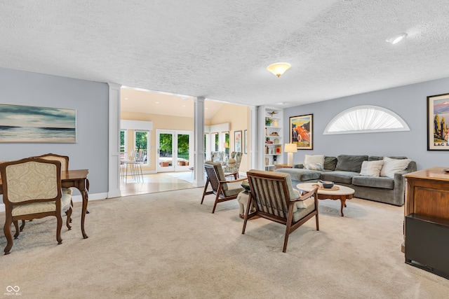 103 Gettysburg, Coatesville, IN 46121 - living room with plenty of natural light, ornate columns, light colored carpet, and a textured ceiling