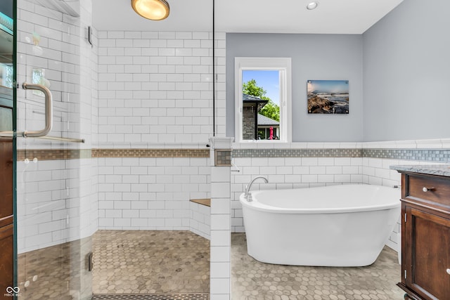 103 Gettysburg, Coatesville, IN 46121 - full bath with a stall shower, tile walls, a freestanding bath, vanity, and a wainscoted wall