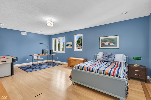 103 Gettysburg, Coatesville, IN 46121 - bedroom with wood finished floors, a textured ceiling, and an office area