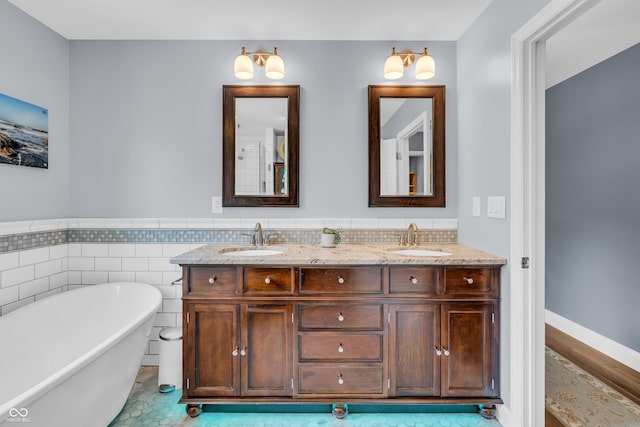 103 Gettysburg, Coatesville, IN 46121 - full bathroom featuring double vanity, a freestanding tub, and a wainscoted wall