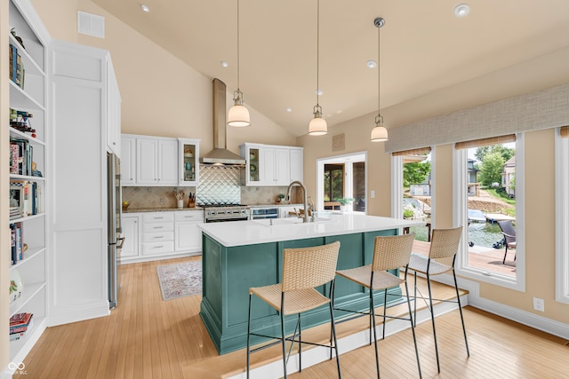 103 Gettysburg, Coatesville, IN 46121 - kitchen with wall chimney range hood, open shelves, light wood-type flooring, high vaulted ceiling, and recessed lighting