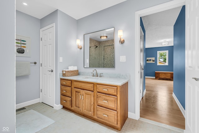 103 Gettysburg, Coatesville, IN 46121 - bathroom with tiled shower, vanity, and wood finished floors