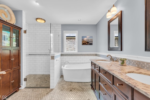 103 Gettysburg, Coatesville, IN 46121 - bathroom featuring a shower stall, a freestanding bath, double vanity, tile walls, and wainscoting