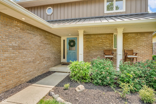 103 Gettysburg, Coatesville, IN 46121 - view of exterior entry featuring a standing seam roof, brick siding, and a metal roof